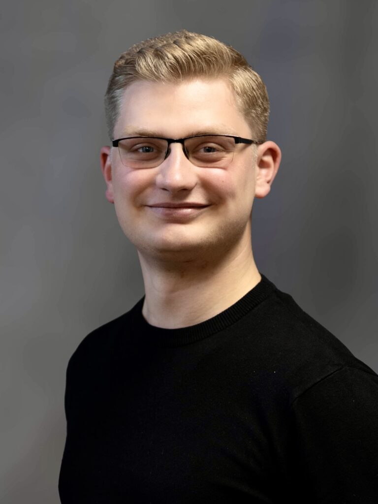Bewerbungsbild eines jungen Mannes mit Brille im Studio